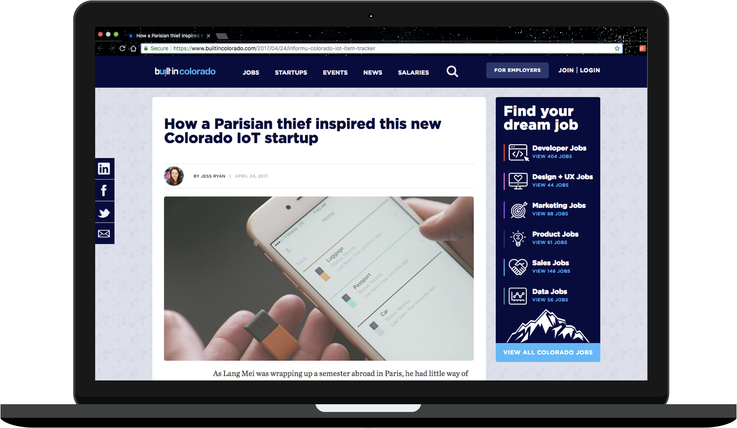 MacBook mockup depicting an article on Built In Colorado titled "How a Parisian thief inspired this new Colorado IoT startup." Jess Ryan is listed as the author, and a photo below the headline depicts a cell phone and a small, rectangular IoT device.